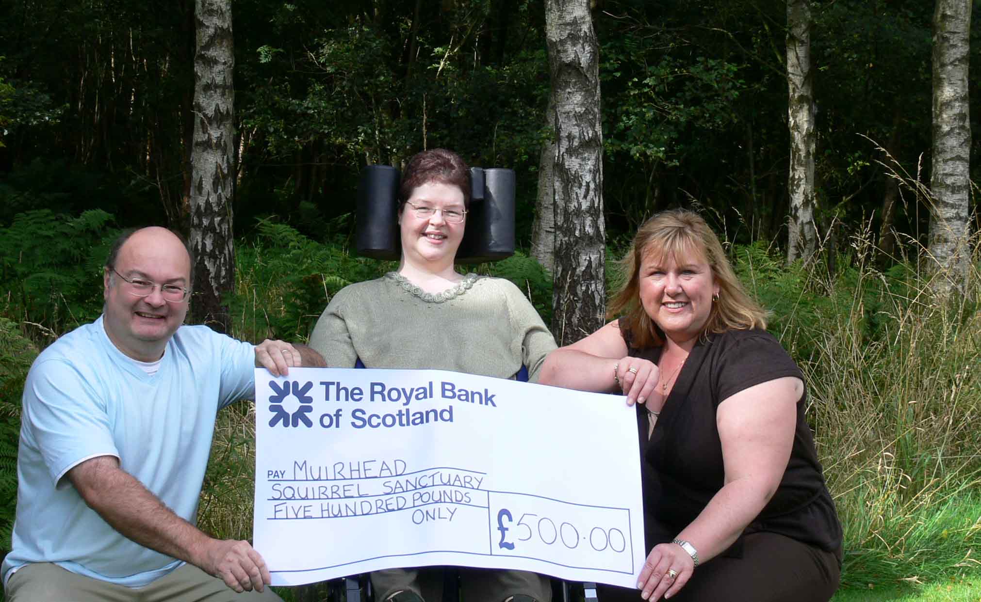 Jimmie & Rosie receiving a cheque from Anne Smith